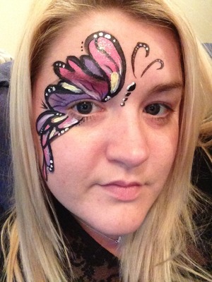 Pretty one sided butterfly design. 
Made with snazeroo face paint. 
Bright pink sparkle 
Pale purple
Pale yellow 
Black
White 