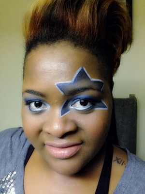 I did this look one Sunday, while watching the game with the hubby. This look can be worn as a regular look (without the star of course). 

Star on left eye was drawn freehand with an eyeliner. (The bottom may not be just right but, I wanted it to line up with my lower lash line.) Use a blue liner and eyeshadow to blend out. Outline star with a white eyeliner. 
