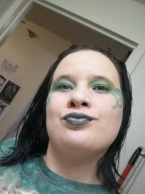 You well for starters need green eye shadow. You start with the eye lids then with you are done you take a small shadow brush and put on green eye shadow then draw the fae wings as I call them. Then when you are done with that the take gold lip stick and bined the green eyes shadow in together.