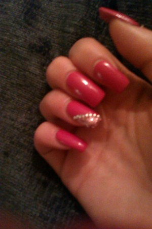 Pink nail varnish on top of acrylics with pretty pink glitter and gems <3