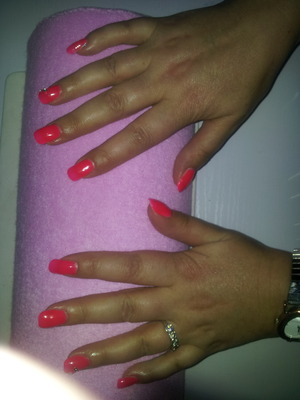 acrylic nails with neon pink orange and 2 dimonds... 