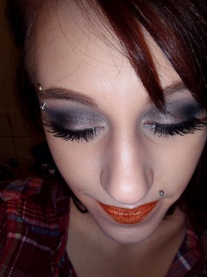 A dark smokey eye, spider-leg-lashes and orange lips is an easy way to make your look go with halloween, without making a costume out of it.