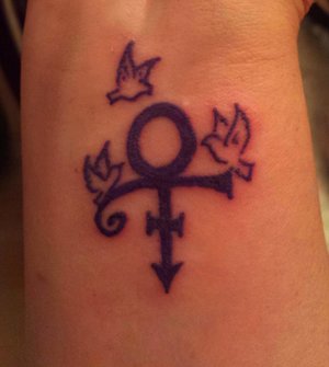 I've been wanting to get a tattoo in honor of Prince since he passed, but wanted to add something to the symbol...thought these 3 doves were perfect!  I grew up listening to Prince - his first album came out when I was 10 years old...saw Purple Rain and Under the Cherry Moon in the theaters...watched him on American Bandstand...truly a tragic loss - not only a great entertainer, but a musical genius, amazing instrumentalist, songwriter, humanitarian, etc. R.I.P. Prince! 