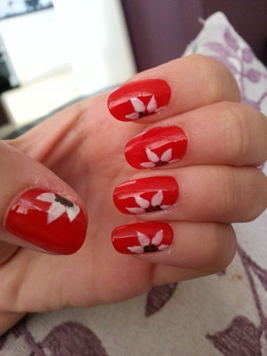 I used and red polish by Rimmel and drew on the flowers with a paint brush :) 