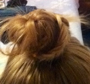 Make a ponytail on top of your head, add some little braids and turn it into a bun. Sorry if you can't see it very well!