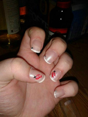 Kiss print in a french manicure look with a small black 'x' 
