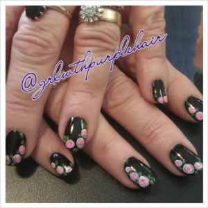 Sweet pink roses on black polish. 