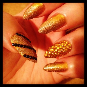 Solid gold coming down to glittery gold and topped the look with some rhinestones to make it festive!