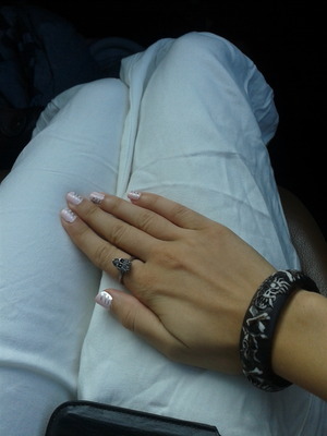 Pink nails, skull bracelet, skull ring