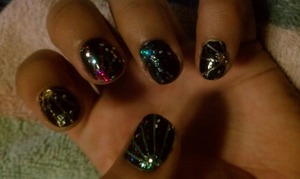 Skittles colors, placed on striping tape, then painted over with black. Added rhinestones and glitter.