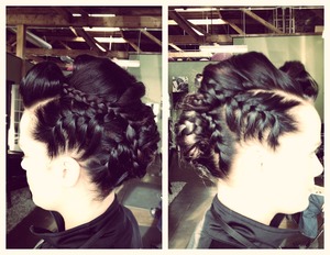 Pin-up style victory rolls with braids up the sides...in the shape of a hawk