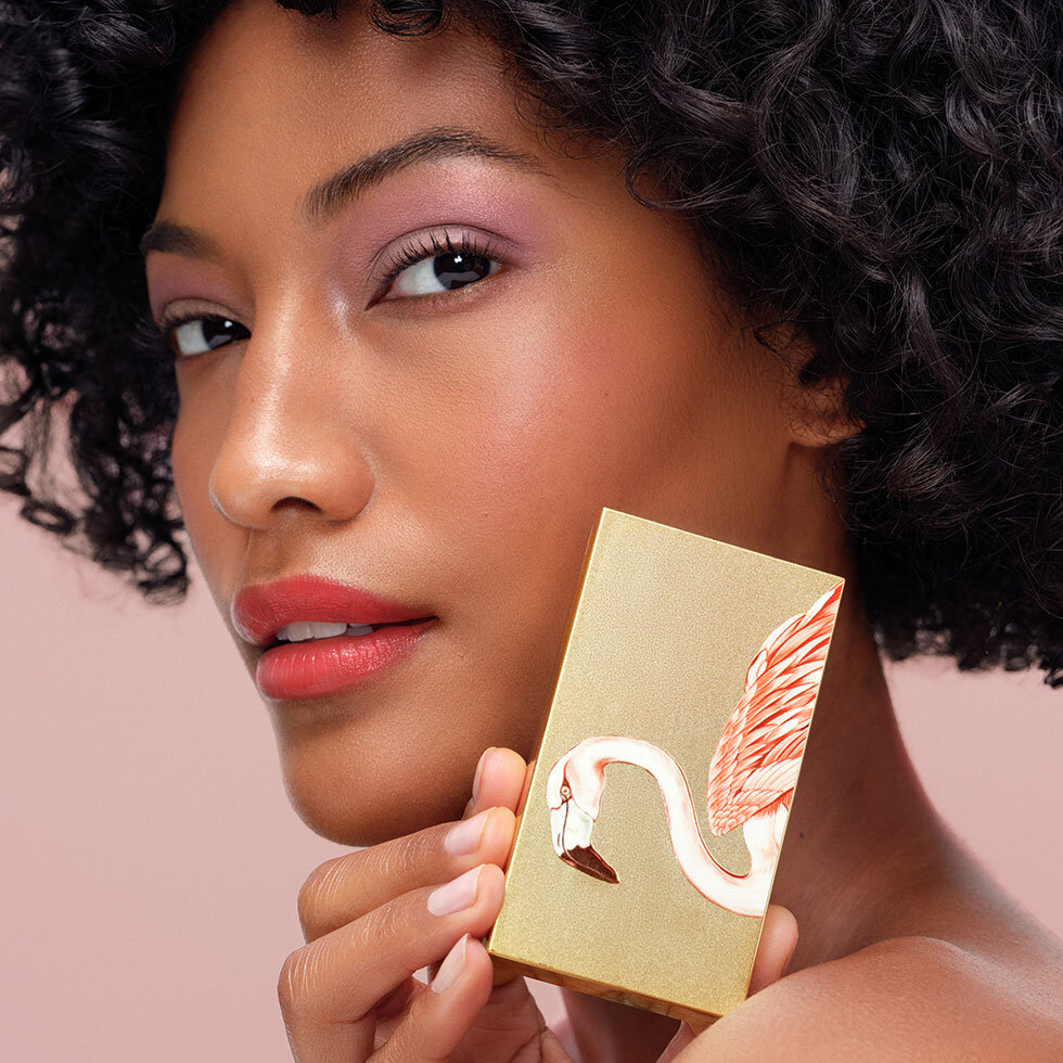 Model holding Chantecaille Eye Trio