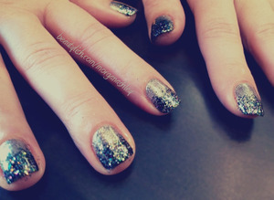 A sizzling summer nights collection gel with loose black and multi glitter on the tips.