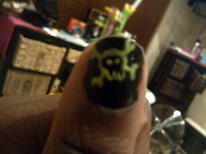 Black base with a lime green skull, hand done 