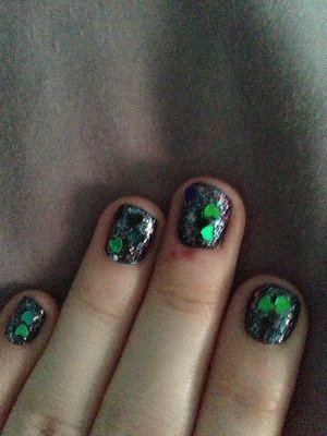I used a sparkly black base, a rainbow glitter, a green glitter, and glitter hearts. 