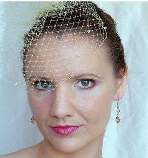 Vintage-look champagne birdcage with crystals atop my pulled-back curls. Glow-y complexion, bold lip and cheek for contrast.