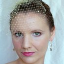 Pulled-back undo with birdcage veil and bold lip
