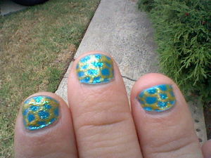 I'm a massage therapist so I have to keep my nails short and stubby, so unfortunately there aren't many designs I can do on them. I did this because I love all things oceany and mermaid related. I used my Avon Nailwear Pro in "Blue Escape", then I did the scales using my yellow Migi Art Pen. Then I used a clear iridescant glitter nail polish to top it off.