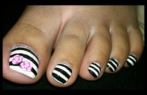 white toe nails with black stripes and a rose fimo accent!! :)