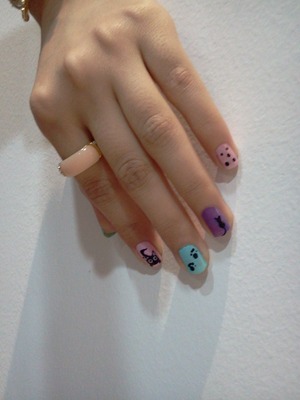 for the basic : 
I used purple and pink nail polishes by H&M and tiffany & co blue color. 
for the cat : 
make an oval in black for the head using dotting tool.make two dots below the head for the legs. and draw tow triangle ears. make two white dots for the eyes and two black dots smaller than the white dots for the lenses. draw a tail in black using striping brush. 
