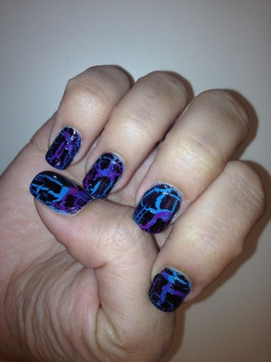 For this look I first used a neon blue and neon purple polish to "water marble" my nails. Then I toned down those colors by covering them with a black crackle polish. 