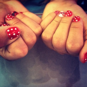 Red Polish with polka Dots and a pretty bow.