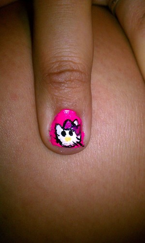 1. Clear Base Coat 
2. Hot Pink background over full nail.
3. Using a dotting tool make hello kitty with white polish.
4. Outline Hello Kitty with black polish also make 2 dots for eyes.
5. With dotting tool make a bow i chose a lighter pink . 
6. With a yellow polish and a dotting tool make a nose.
7. Clear top coat to seal in design. 