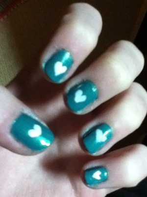 Blue green nails with white hearts <3