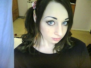 Light make up and curled pigtails