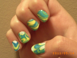 This was my first ever water marble. Considering that, I think it was pretty good. I'm much better now but considering it was my first time I'd say it isn't half bad. 

For this design I used:

Sally Hansen Xtreme Wear- White On (base)
Sally Hansen Xtreme Wear- Mellow Yellow
Sally Hansen Xtreme Wear- Blizzard Bue
Sally Hansen Xtreme Wear- Blue Me Away