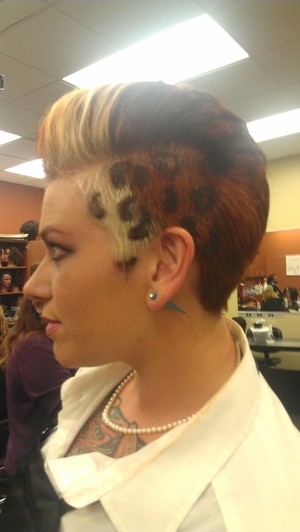 two toned fohawk , shaved sides with leopard spots , 