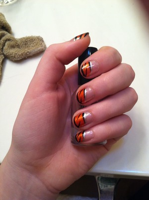 Really simple nails, all u need is thin black and silver and regular orange nail polish
