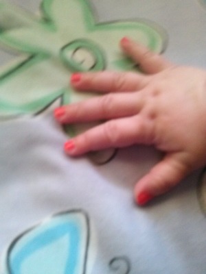 blurry pic,  bit you can see her lil fingers.  hard to get a 1 year old to stay still but I managed to do it(: