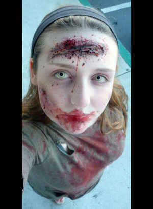 Gory zombie look with prosthetic wounds and costume contact lenses. For more information please see my MakeupBee profile.