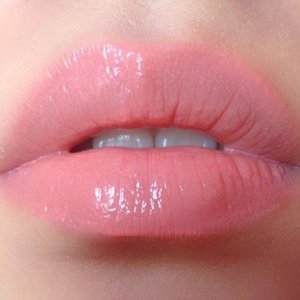 A MAC coral combination of "Coral Bliss" lipstick & "Talk Softly To Me" lipglass.