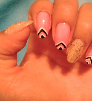 Accent nails in nude and gold, with the rest of the nails in a pink color with black and white triangles
