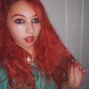 Red hair and heavy goth eyeliner