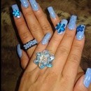 blue nails with sparkles and oversized flower gems