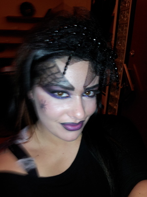 .dark styled spider web makeup.