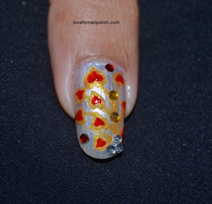 Detail Tutorial http://lovefornailpolish.com/red-gold-nail-design-heart-leaves-cute-design-for-valentines-day