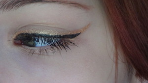 Black winged liner with a gold accent.  Using my trusty Urban Decay Half Baked of course!
