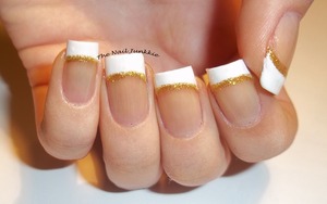 A simple French manicure with gold glitter border 