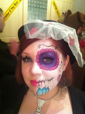 Dia de los Muertos inspired half skull face for a halloween party - hence people in the background! Took me about an hour and I used whatever make up was in my cosmetics drawer except for the white base which was  face paint.