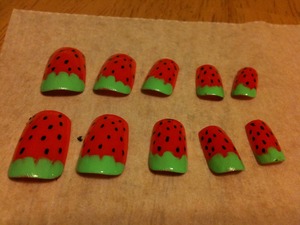 1. Red base coat
2. Pick a side you want for the leaves and add green
3. Using a dotting tool or nail pen draw seeds
4. Top coat

Optional: You can make the "leaves" straight and you'll have watermelon nails