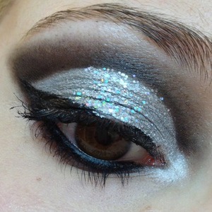 For the new Bond film I wanted to do a very dramatic and glamorous look fit for a Bond girl, but I think I ended up with more of a femme fatale appearance.

I was quite happy with it either way and it was a glitzy, silver spin on my usual go-to look. I couldn't resist using the two types of glitter; Eye Kandy Jawbreaker mixes so well with Sugarpill Tiara and M.A.C Reflects 3D Silver is awesome. 