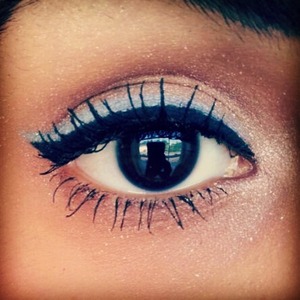 Simple yet fun eye look. Light blue eyeshadow applied with a fine point brush and liquid black eyeliner. 