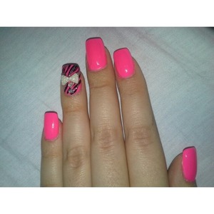 Nails done pink with zebra print and bow