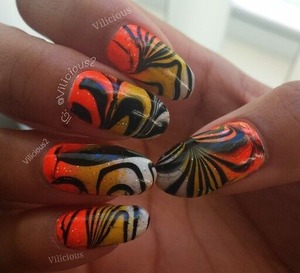 This was a candy corn inspired water marble mani from last month. ^_^ For the base of the water marble mani, I did a gradient using Orly Melt Your Popsicle, Hard Candy Splendid, & Sally Hansen White On. For the water marble I used Sally Hansen Black Out & a clear nail polish.
I layered a coat of Orly Shine On Crazy Diamond After I allowed the water marble to dry a bit.