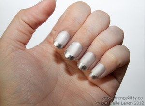 Silver French tips. Tutorial here:
http://strangekitty.ca/friday-nails-silver-surfer/