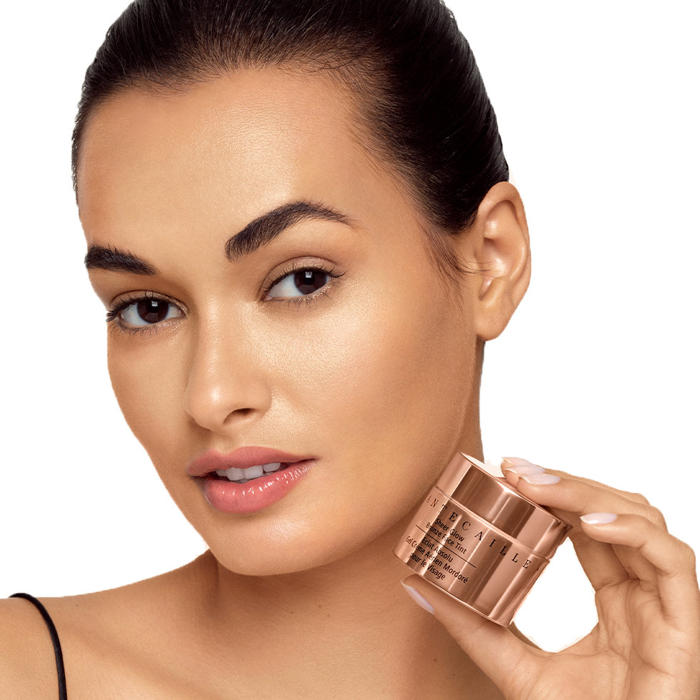 Chantecaille model holding the Sheer Glow Bronze Face Tint